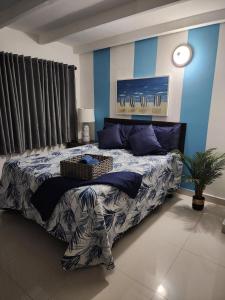 a bedroom with a large bed with blue walls at STARFISH LUXURY APARTMENT in San Juan