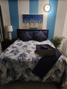 a bedroom with a bed with a basket on it at STARFISH LUXURY APARTMENT in San Juan