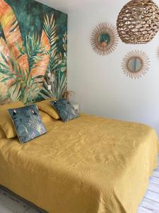 um quarto com uma cama com duas almofadas em Chai Saint Jean CAMELIA Piscine et SPA em Saint-Jean-de-Boiseau