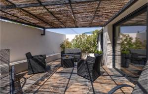 a patio with a table and chairs on it at Beautiful Home In Les Angles With 3 Bedrooms, Wifi And Outdoor Swimming Pool in Les Angles Gard