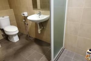a bathroom with a toilet and a sink at KLCC Luxurious 2 Floors Homestay 5BR for 15pax in Kuala Lumpur