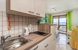 a kitchen with a sink and a counter top at Cozy Apartment In Crikvenica With Heated Swimming Pool in Crikvenica