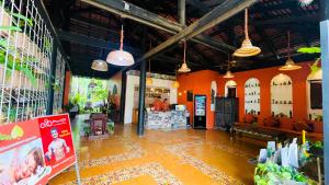 a large room with orange walls and a store at Residence Indochine Suite in Siem Reap