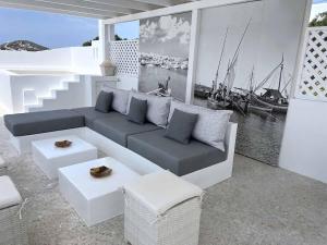 a living room with a couch and a table at Blue Dolphin Antiparos Villas and Suites in Agios Georgios