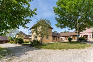 an exterior view of a house with trees at Gîte Cascades des Tufs 2 pièces piscine in La Châtelaine