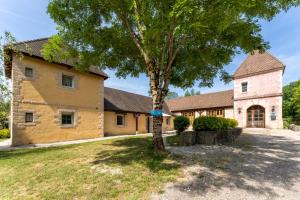 a house with a tree in front of it at Gite Chateau 3 chambres piscine chauffée in La Châtelaine
