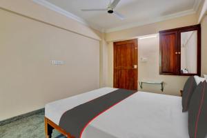 a bedroom with a bed and a wooden door at Family Castle Inn in Trivandrum