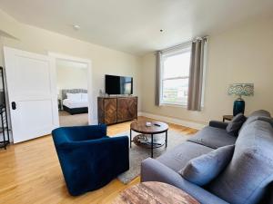a living room with a couch and a tv at Downtown Digs-View of the City! Stay above local restaurants and nightlife, posh amenities heated toilet seat, oversized rain shower head in glass shower, in-unit laundry, one garage parking spot in Boise