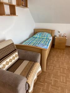 a small bedroom with a bed and a couch at Apartment Blick auf Schloss Herkules Kassel in Kassel