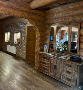 a bathroom with a vanity with a large mirror at Viesu nams Vālodzes in Sigulda