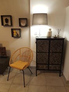 a room with a chair and a dresser at Appartement terrasse vue mer LeMaxime St Gilles les Bains in Saint-Gilles les Bains