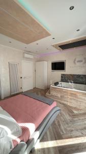 a bedroom with a bed and a tv on the wall at Suites Matteotti 57 in Civitavecchia