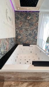 a bath tub in a room with a wall at Suites Matteotti 57 in Civitavecchia