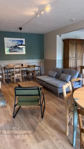 a living room with a couch and tables and chairs at Auberge de Sauze in Sauze