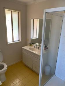 a bathroom with a sink and a toilet at Open 4 bedroom home in Warrnambool