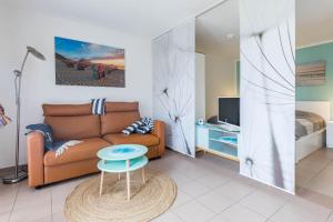 a living room with a couch and a table at FeWo Blåkulle im Haus Seeblick - Wohnung 11 in Hohenkirchen