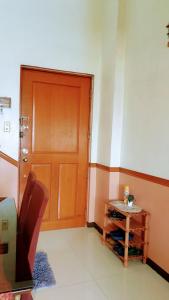 a room with a door and a table in front of it at Greenhills Garden Square 2BR & 2 Toilets in Manila