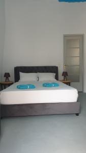 ein Schlafzimmer mit einem Bett mit zwei blauen Platten darauf in der Unterkunft StathisApart1 in Amorgós