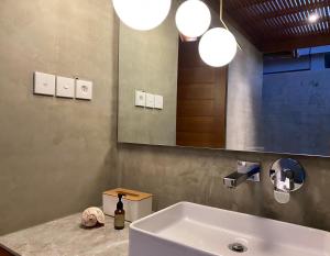 a bathroom with a sink and a mirror at Dewa Hostel in Ubud