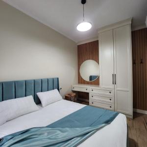 a bedroom with a bed and a white cabinet at PineTrees Beach House with swimming pool in Golem