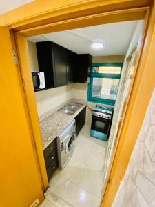 a small kitchen with a sink and a stove at Studios for Female in Dubai, Marina in Dubai
