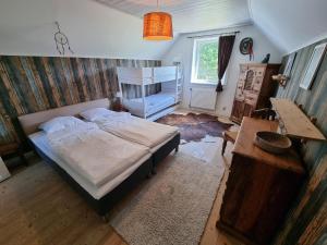 a bedroom with a bed and a table and a desk at EddyLou Ranch in Slöinge