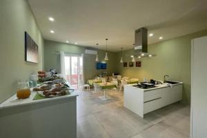 a kitchen and dining room with a counter with fruits on it at B&B La Nuit in Agrigento