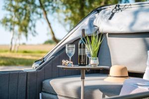 a table in the back of a van with a wine glass at Marina Martinshafen - Beach life in Sassnitz