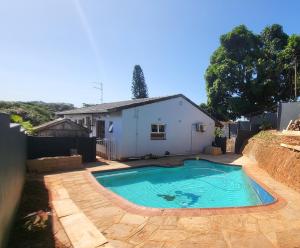 a small swimming pool in front of a house at Generosa of the North in Durban