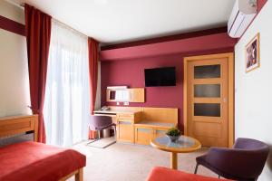 a hotel room with a red wall at Jan Maria Hotel & Restaurant in Ostrava