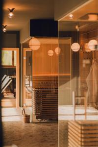 a glass storefront with a piano in a room at The Comodo Bad Gastein, a Member of Design Hotels in Bad Gastein