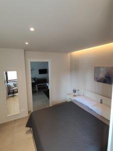 a bedroom with a bed and a living room at Casa Italo in Gardone Riviera