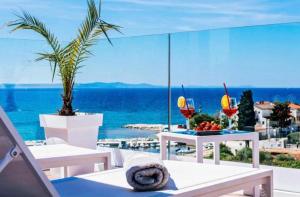 a view of the ocean from a balcony with tables and chairs at Dedaj Resort - Villa Almaro in Zadar