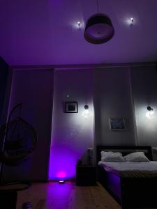 a purple room with a bed and a purple light at Appartment in heart of tbilisi in Tbilisi City