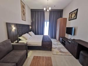 a hotel room with a bed and a couch at NEW DREAM PLAZA HOTEL APARTMENT L.L.C in Dubai