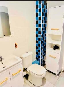 a bathroom with a white toilet and a sink at Face a la mer Fleury in Fleury