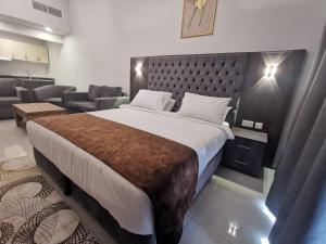 a bedroom with a large bed and a living room at NEW DREAM PLAZA HOTEL APARTMENT L.L.C in Dubai