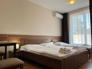 Postel nebo postele na pokoji v ubytování Hotel Aréna