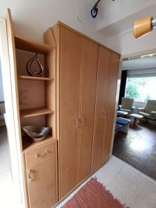 a room with wooden cabinets and a living room at Casa Lauda in Pillichsdorf in Pillichsdorf