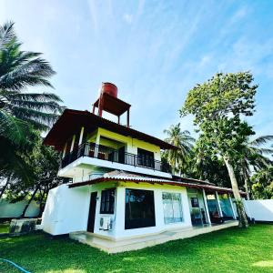 a building with a lighthouse on top of it at Lake View Cottage in Tissamaharama