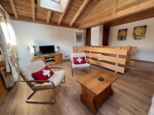 a living room with a chair and a coffee table at ZE Mountain Lodge, Morgins in Morgins