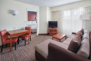 a living room with a couch and a table in a hotel room at Residence Inn Cranbury South Brunswick in Cranbury