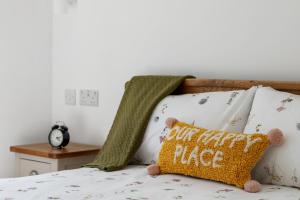 a bed with a pillow that reads cut happyride at Newly Refurbished 2 Bed Flat in Mill Hill