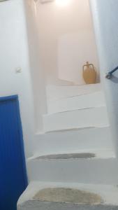 a set of stairs with a purse sitting on them at Stathis Apart 2 in Amorgos
