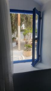 an open window with a view of a patio at Stathis Apart 2 in Amorgos