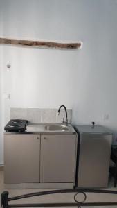 a kitchen with a sink and a counter top at Stathis Apart 2 in Amorgos