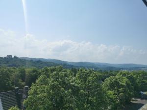 a view of the mountains from the balcony of a house at Moderne Ferienwohnung Iserlohn 1 in Iserlohn