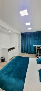 a room with a large bed with a blue rug at Apartments Lomara in Dubrovnik