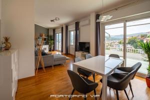 a living room with a white table and chairs at Seaview Flat by PortofinoVip AC, Parking,Terrace in Rapallo