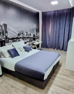 a bedroom with a large bed with a city backdrop at Apartments Lomara in Dubrovnik